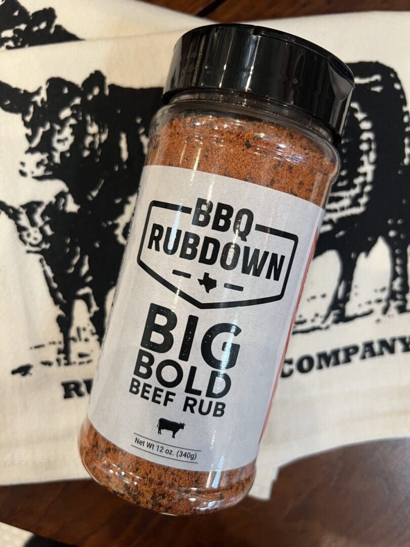 A bottle of bbq rub sitting on top of a table.