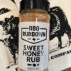 A jar of bbq rub sitting on top of a towel.