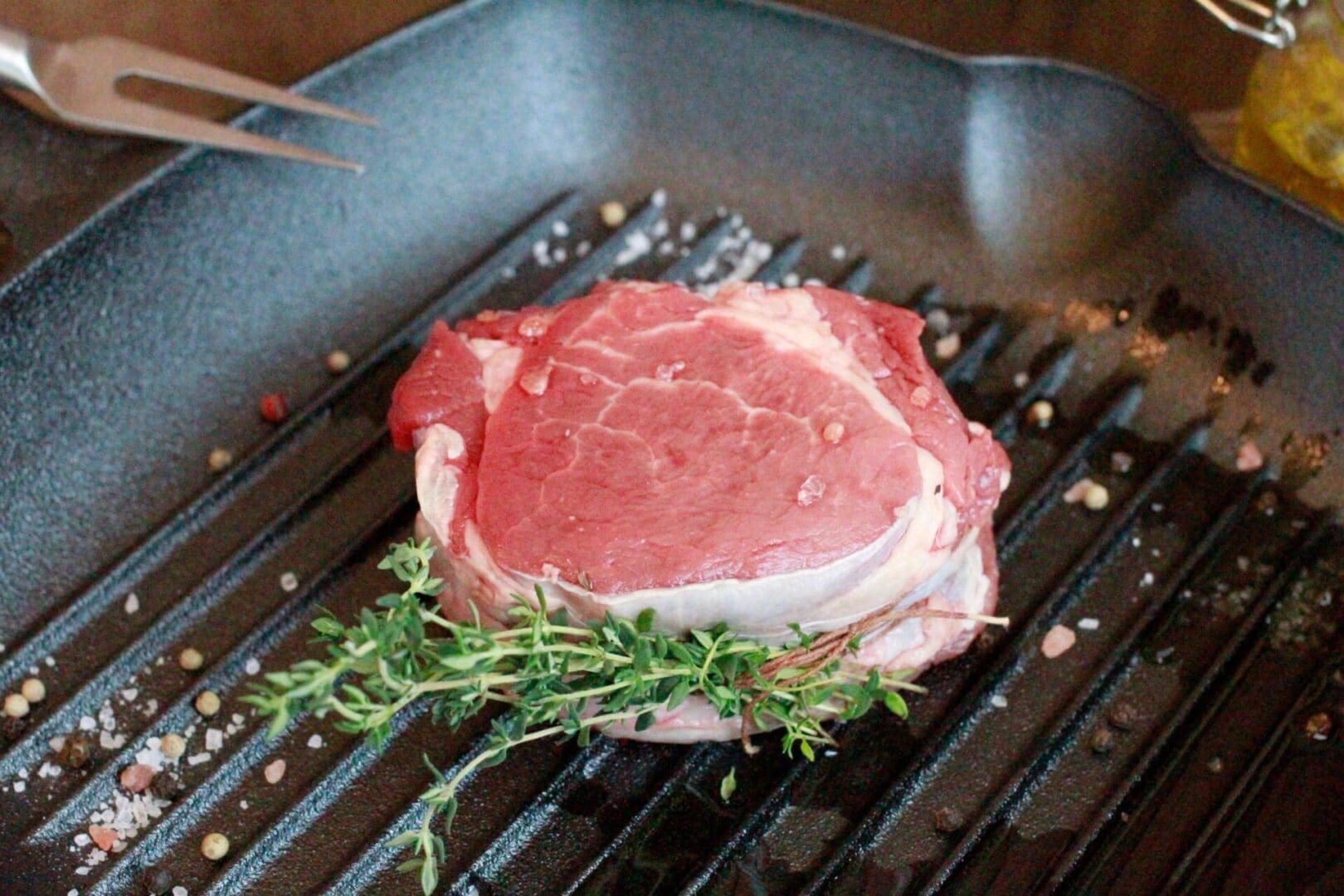 A piece of meat is sitting on the grill.