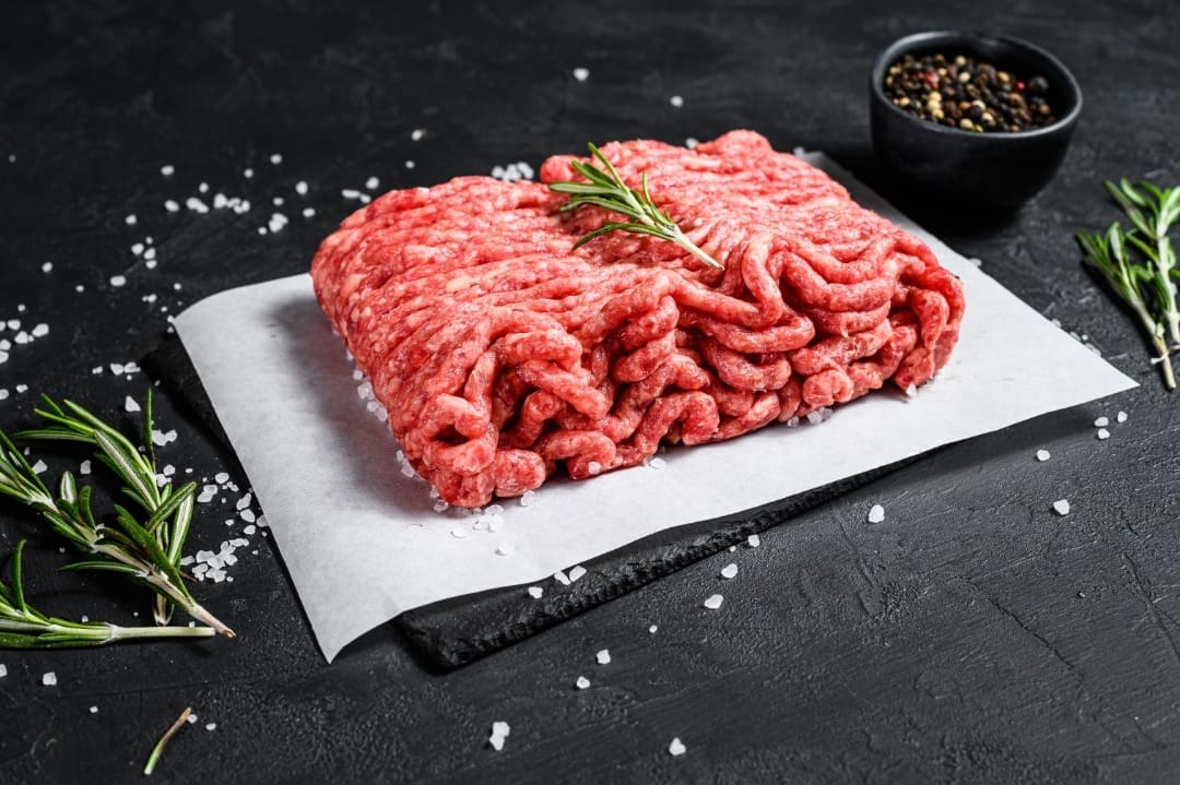 A raw ground beef on top of paper.