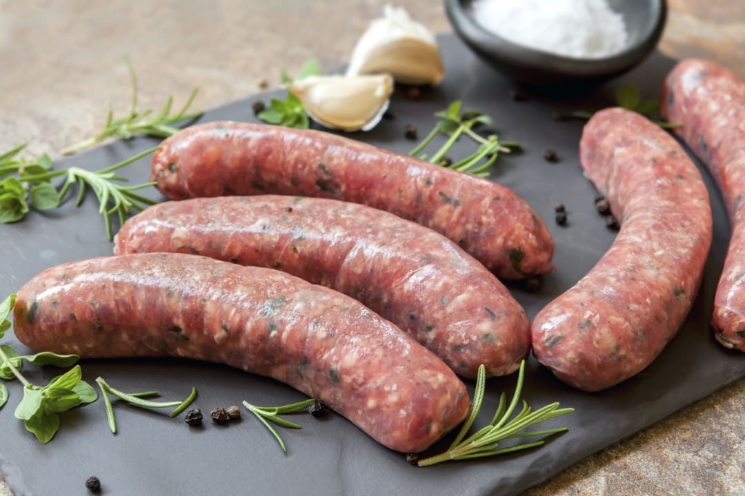 A bunch of sausages sitting on top of a table.